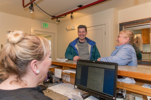 front desk helping patients at all smiles family dental