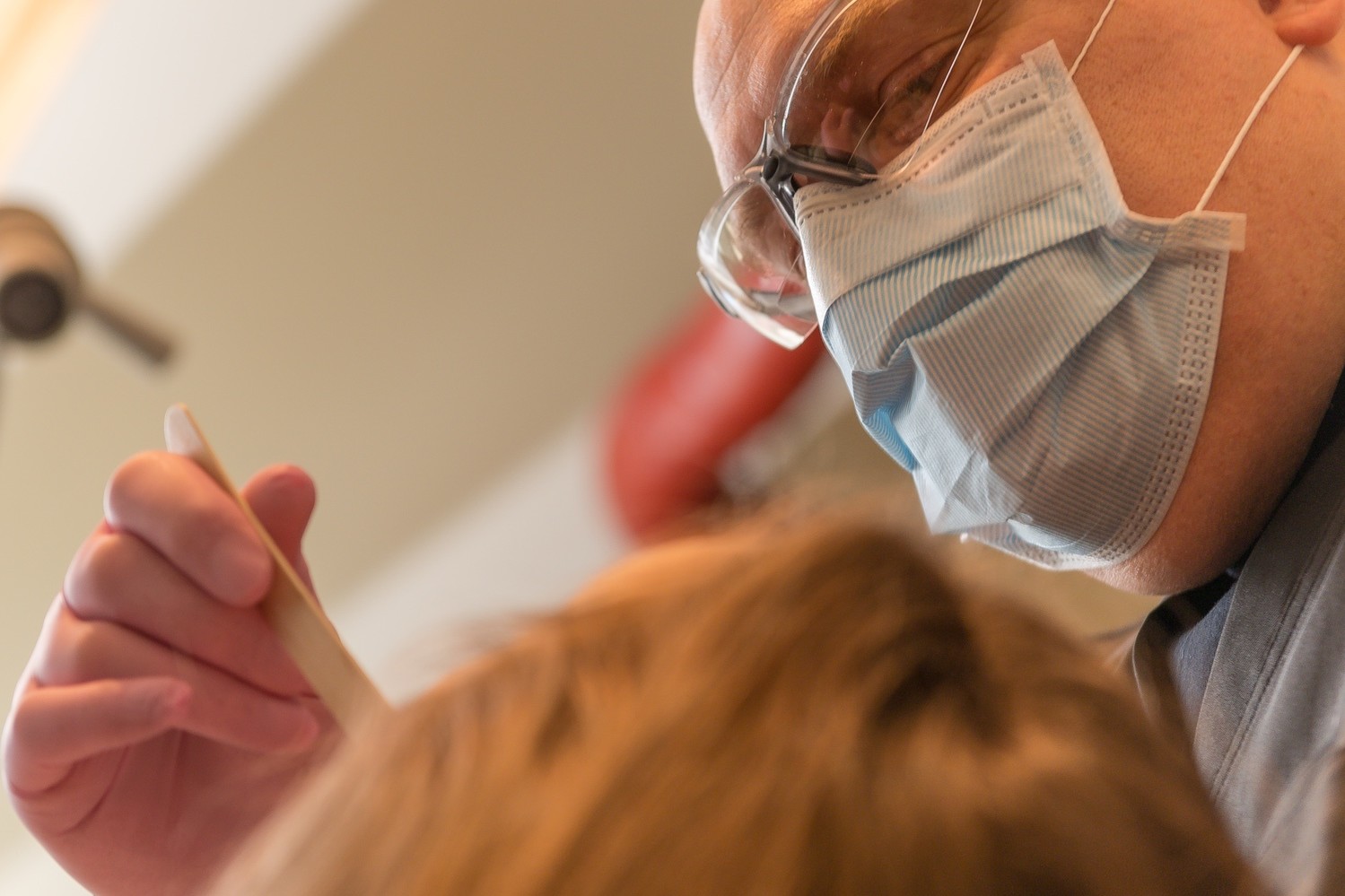 dentist in mask working on patient